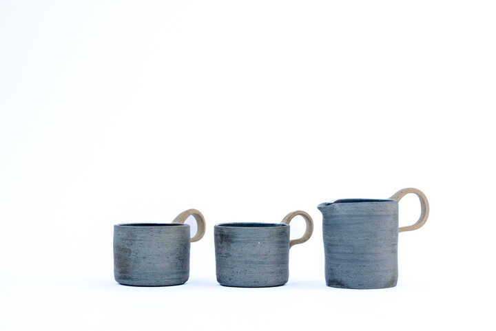 two handmade cups and a handmade jug